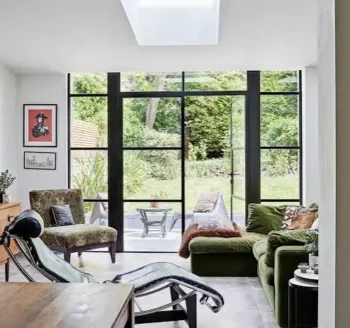Contemporary living room with large windows, comfortable seating, and minimalist interior.