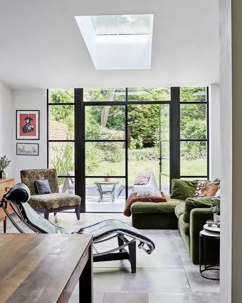 Contemporary living room with large windows, comfortable seating, and minimalist interior.